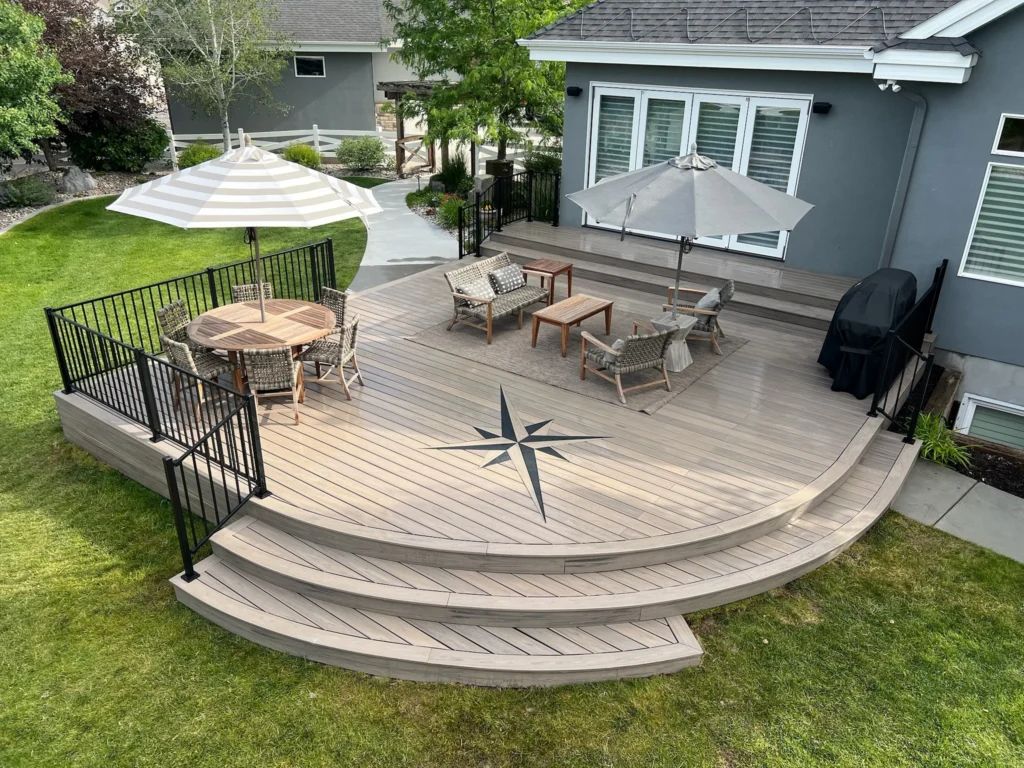 Modern composite deck with curved stairs and compass rose inlay.