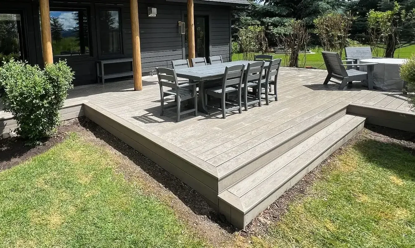 Modern ground level deck with outdoor dining set and seating