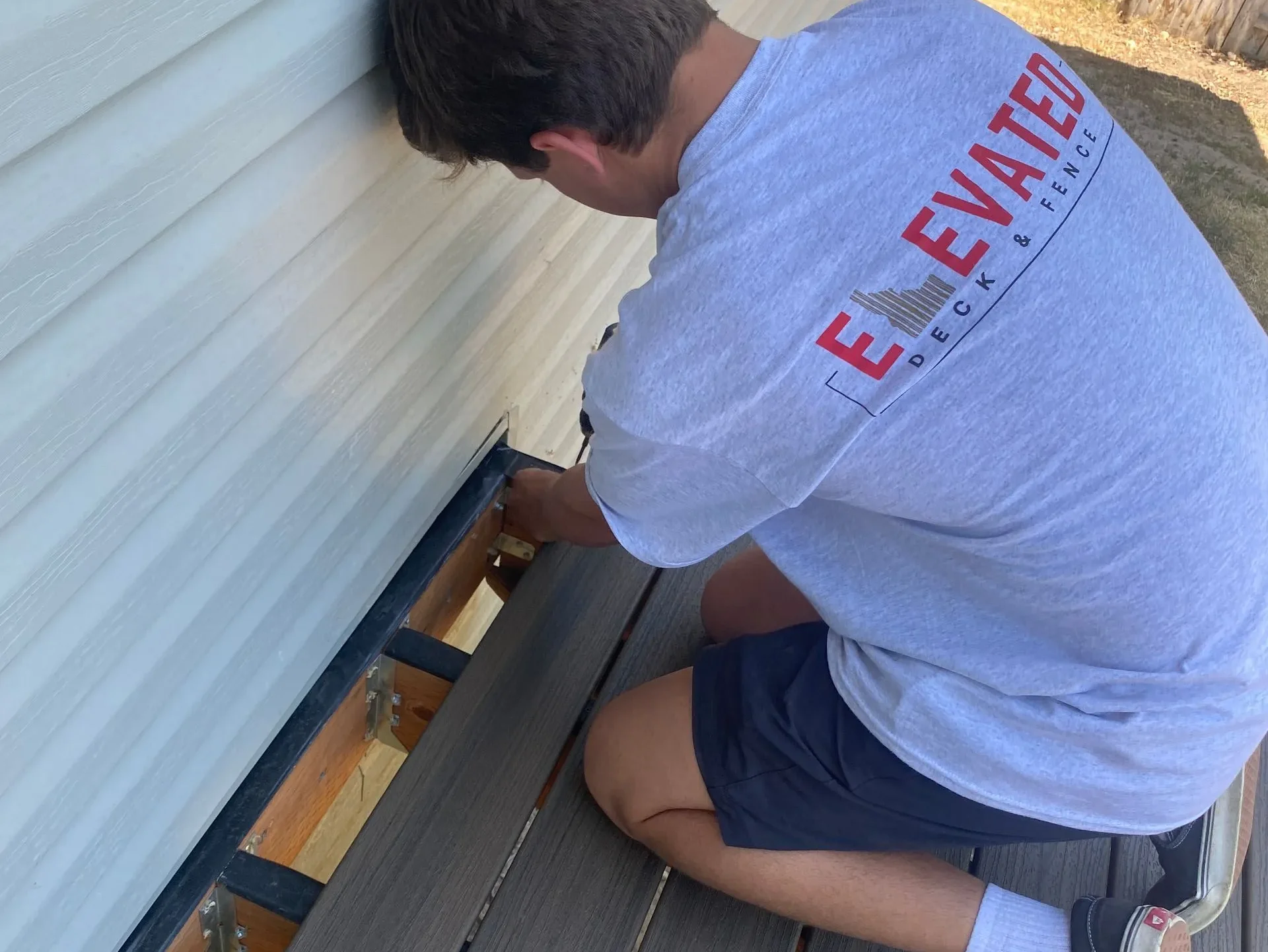 Deck contractor installing new deck boards.